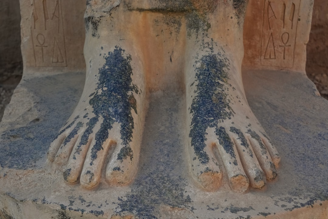 persons feet covered with sand