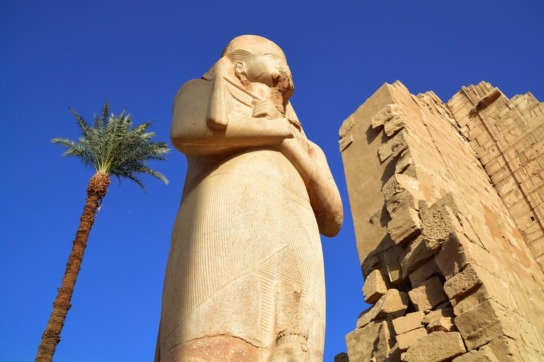 brown concrete statue under blue sky during daytime