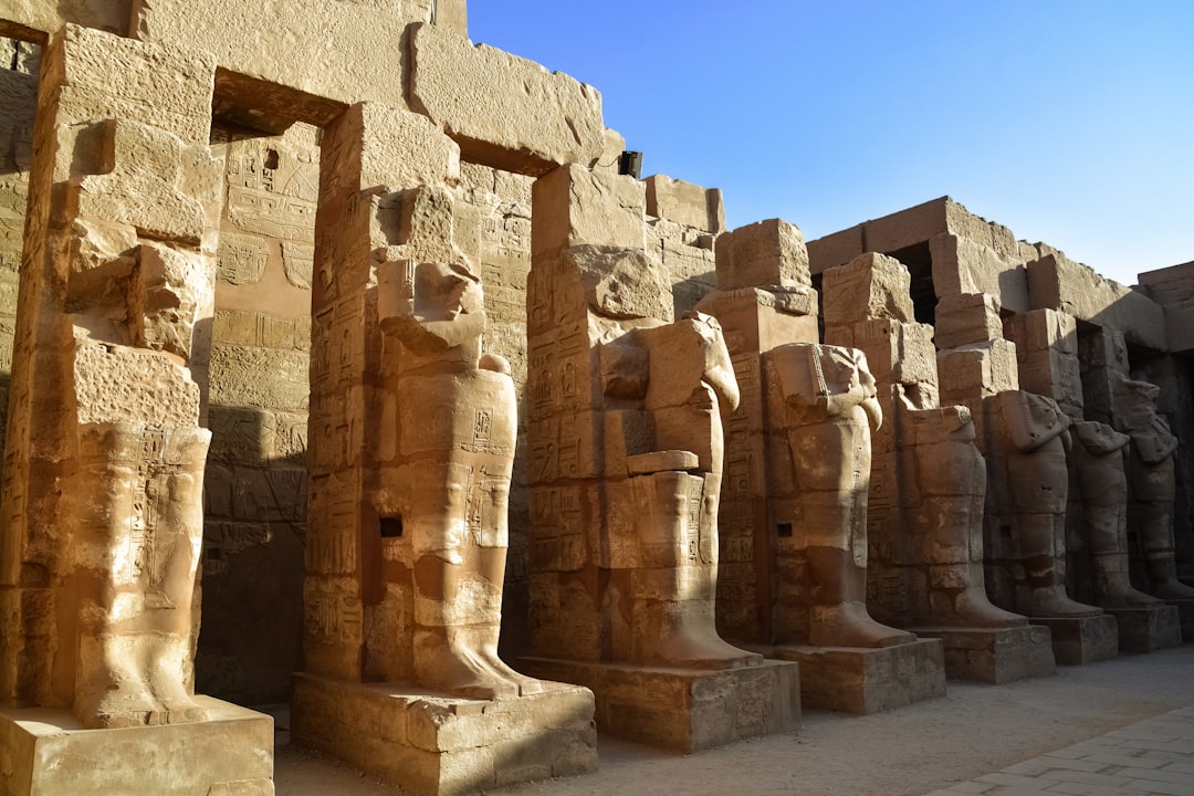 brown concrete statues under blue sky during daytime