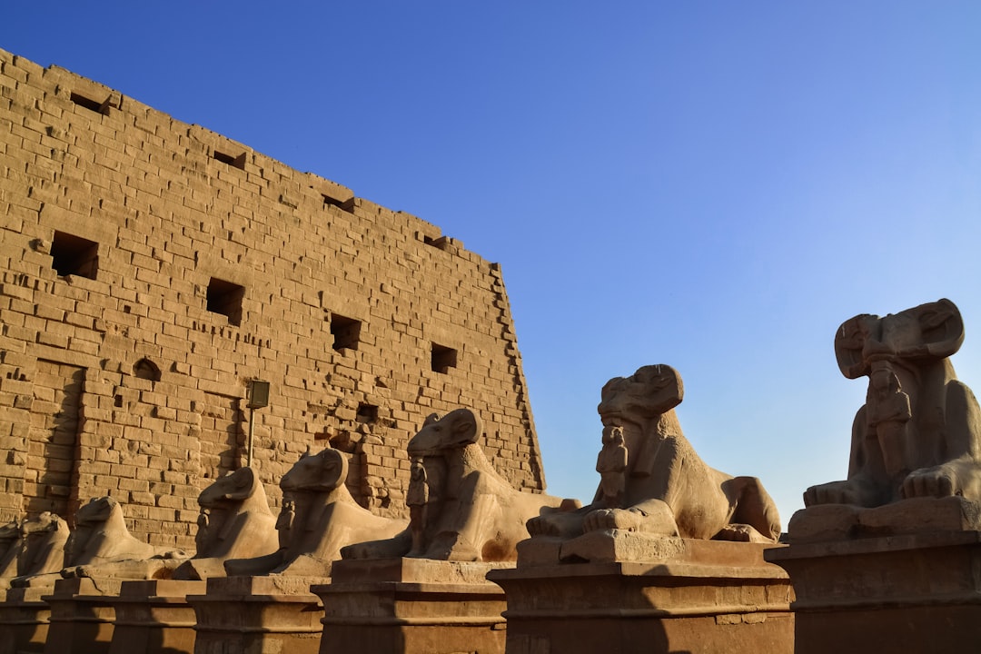 brown concrete statues under blue sky during daytime