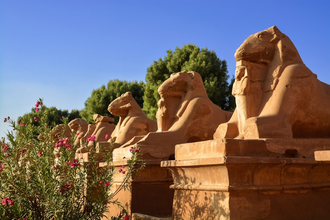 brown concrete statue under blue sky during daytime