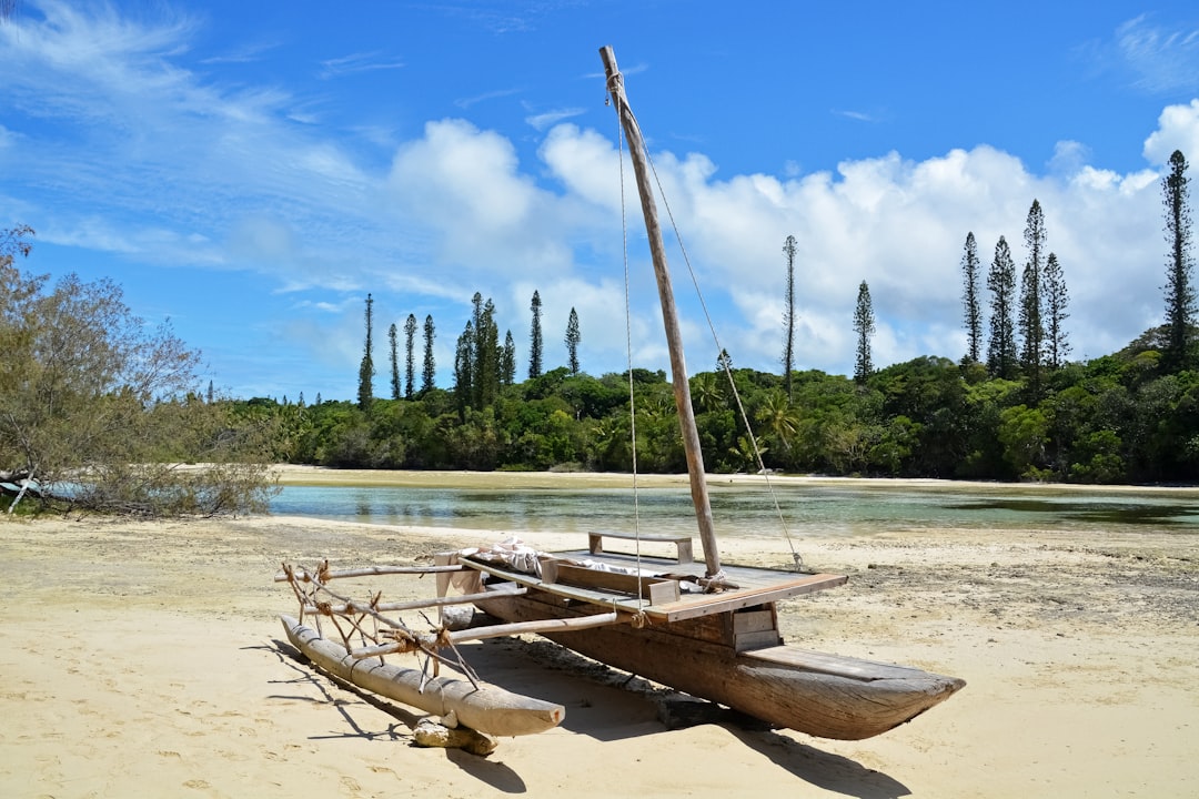brown wooden boat on white sand during daytime