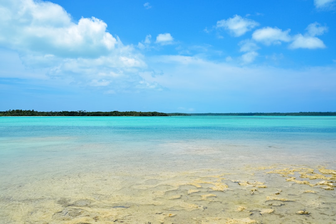 blue sea under blue sky and white clouds during daytime