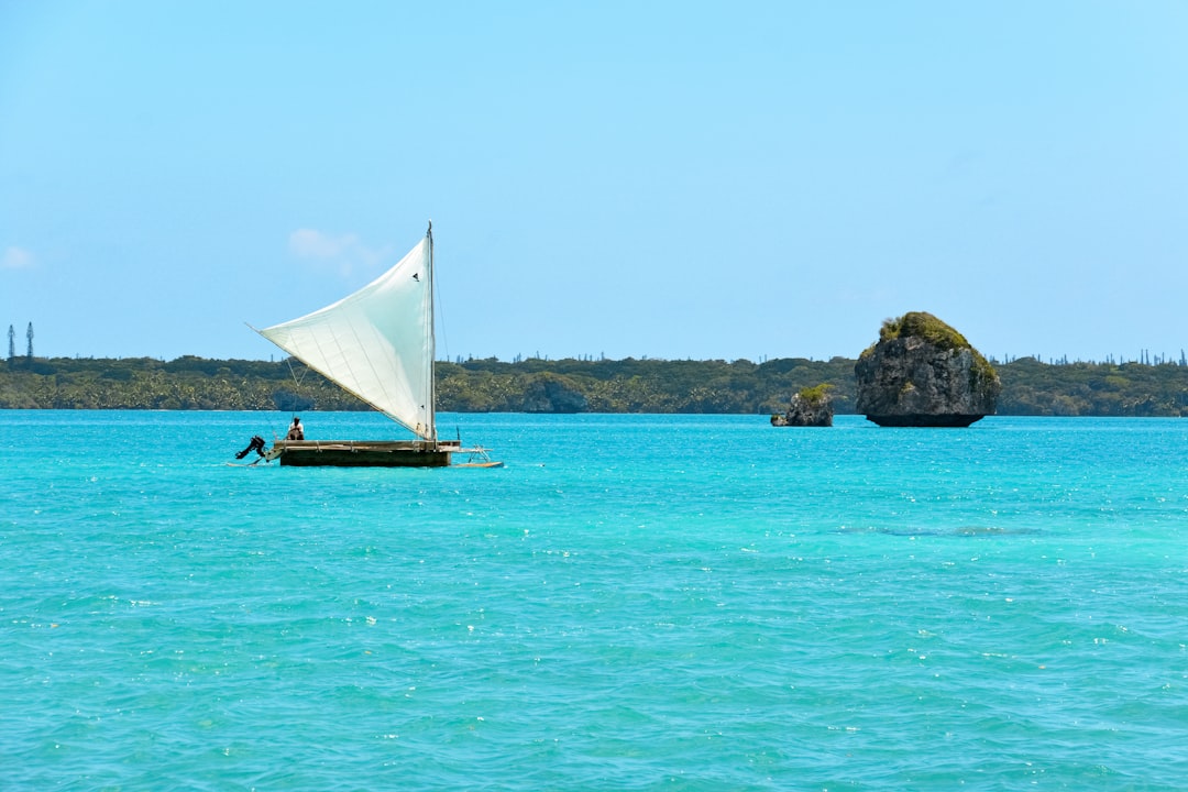 white sail boat on blue sea during daytime