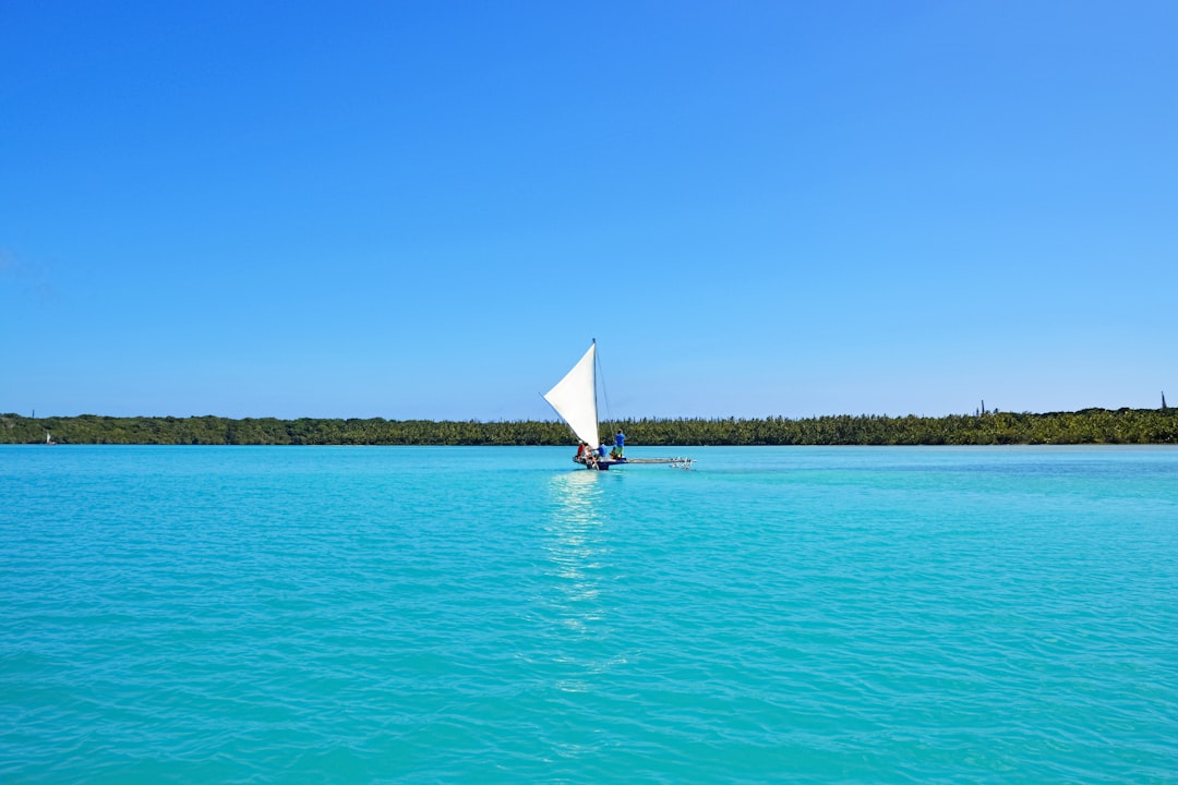 white sail boat on sea during daytime