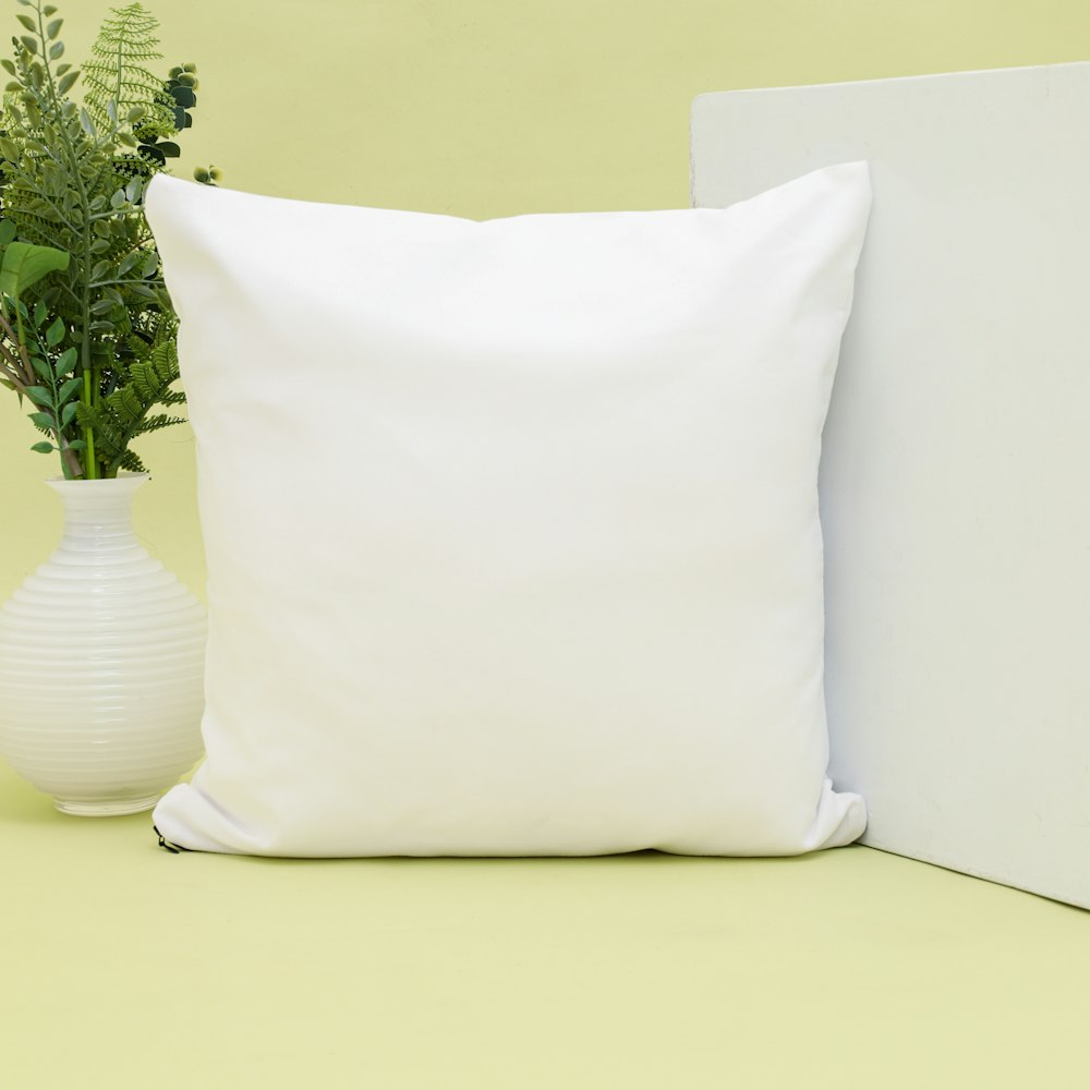 white throw pillow on white couch