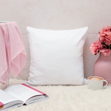 white throw pillow on bed