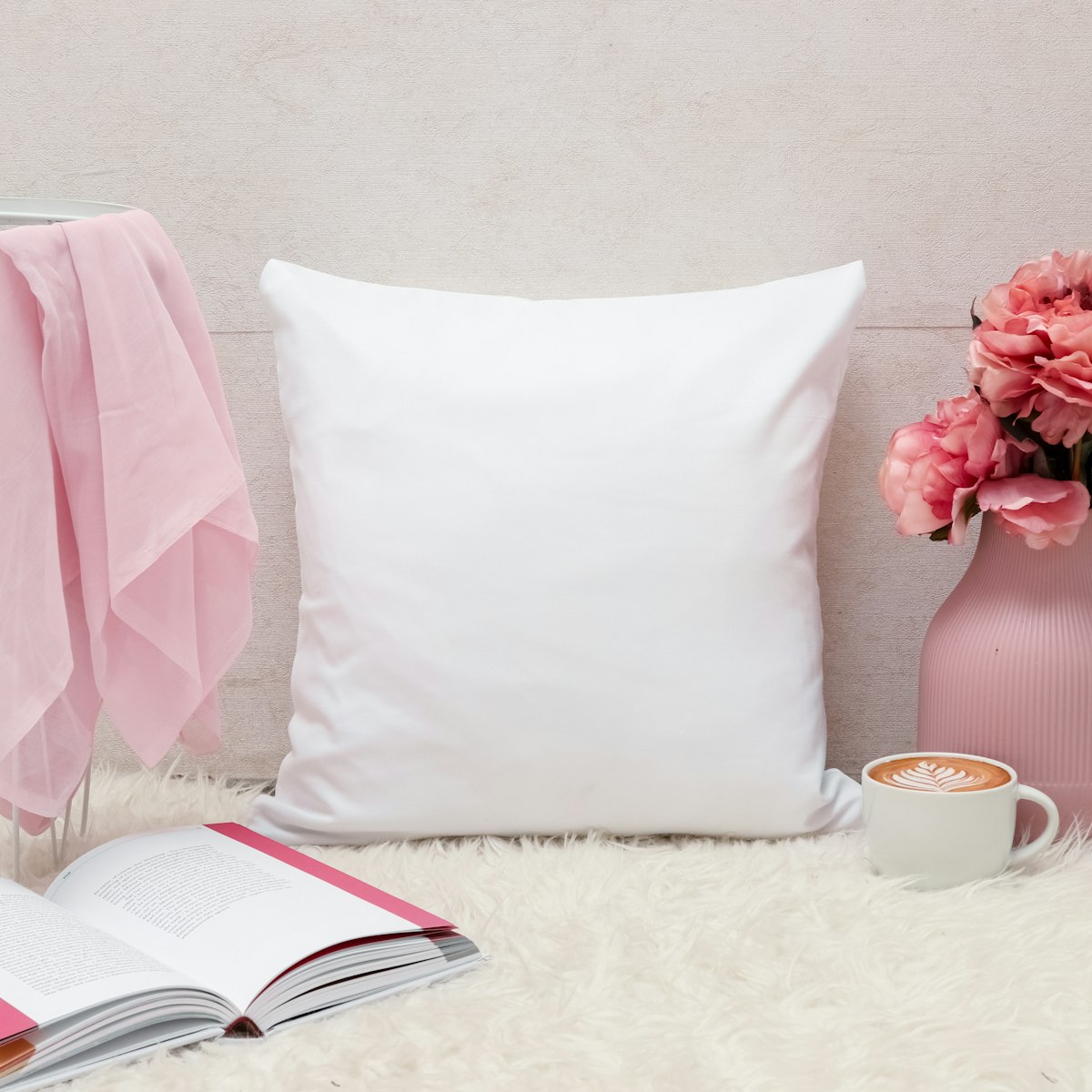 White throw pillow on a bed