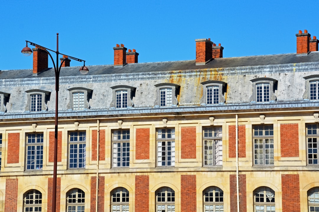 brown and white concrete building under blue sky during daytime