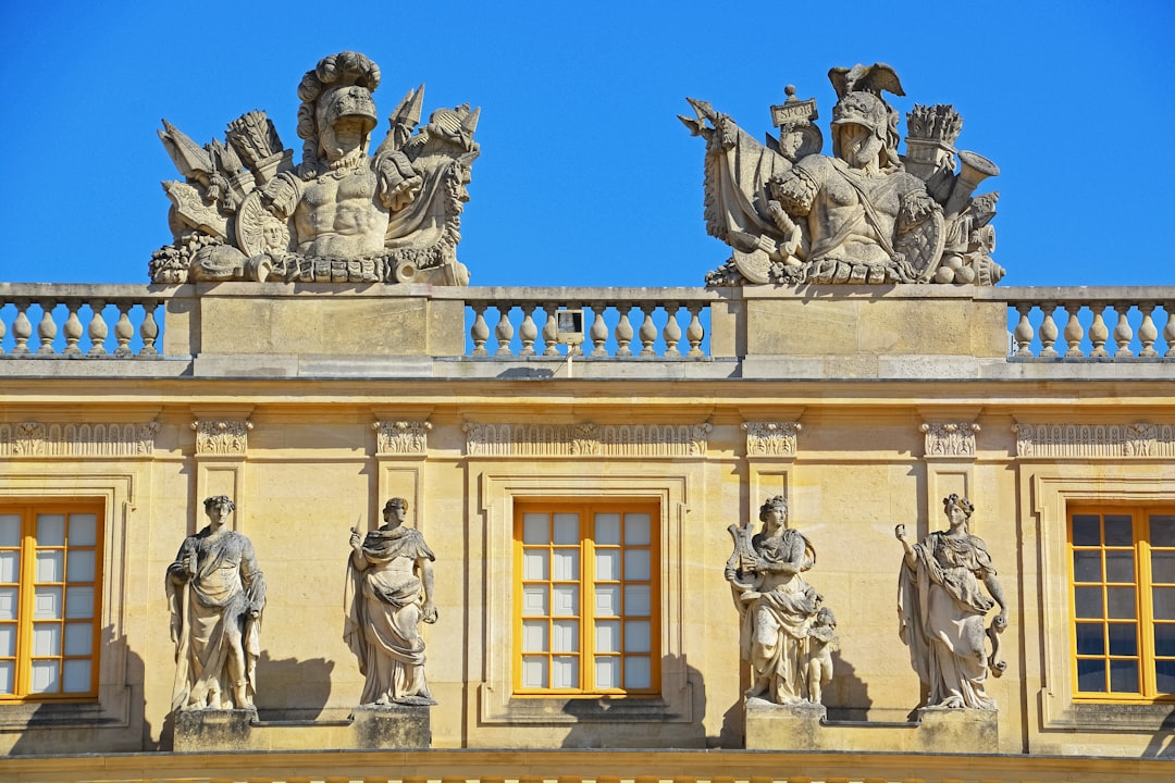 white concrete building with statues