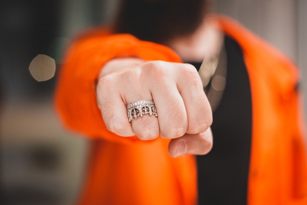 silver diamond ring on orange textile