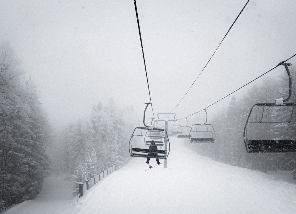 black cable car over snow covered ground