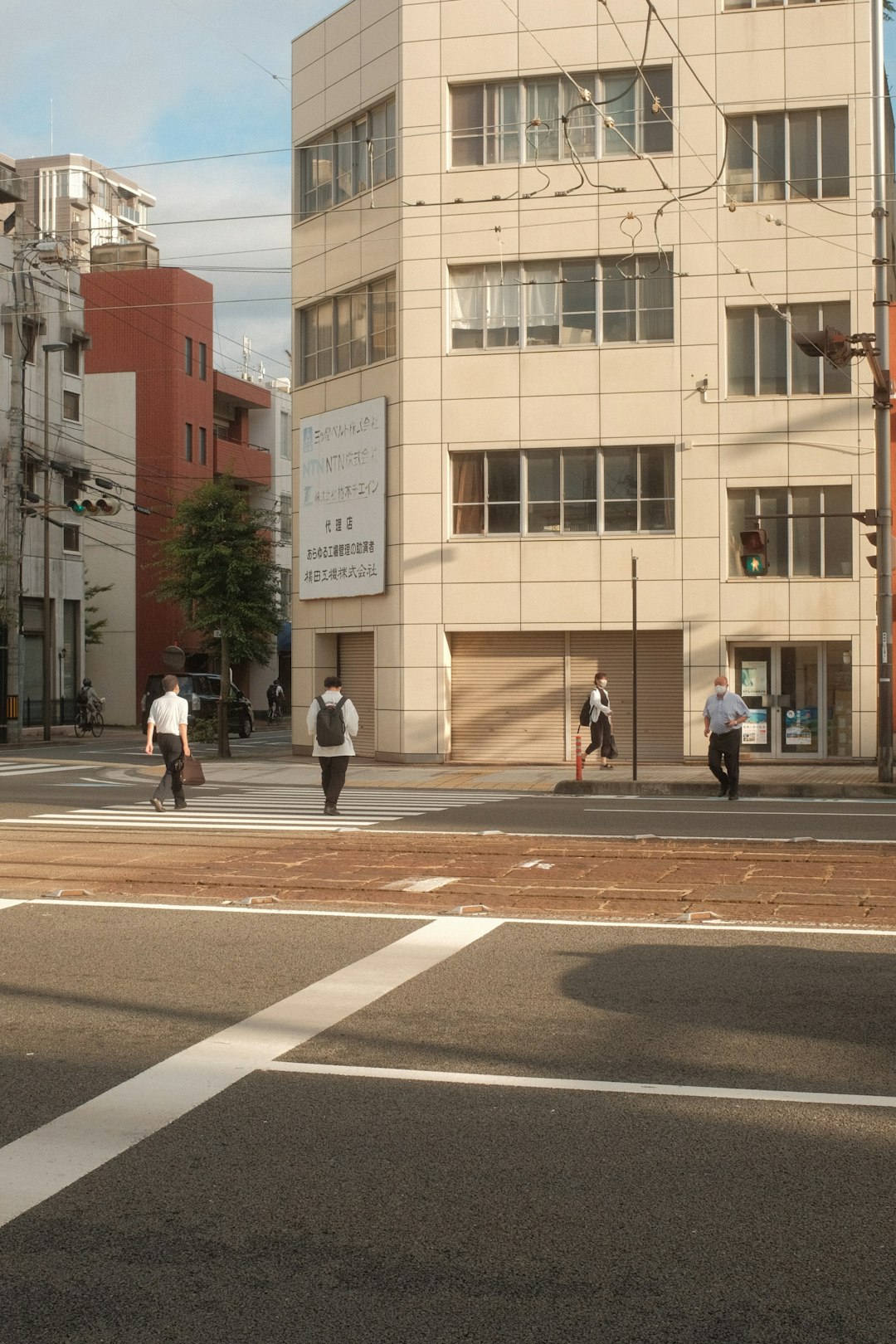 people walking on pedestrian lane near brown concrete building during daytime