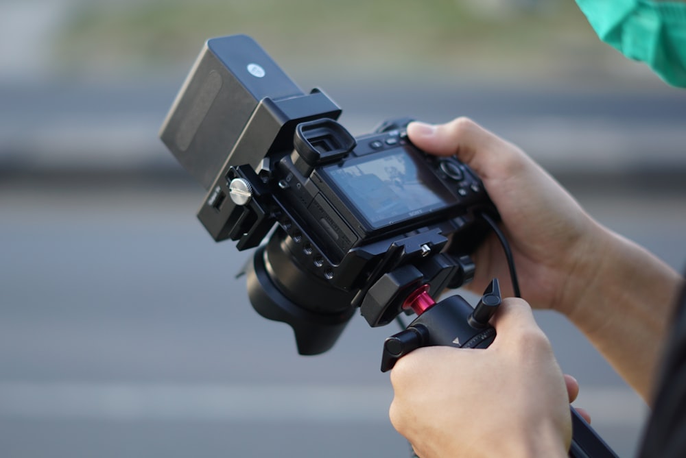 person holding black video camera