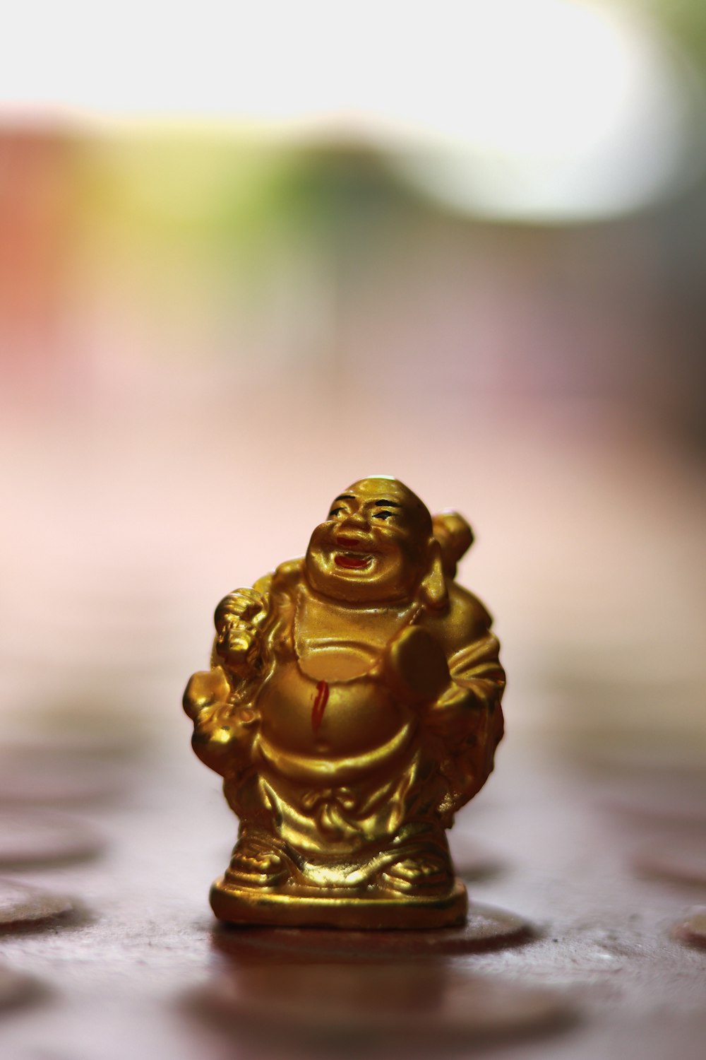 gold buddha figurine on white surface