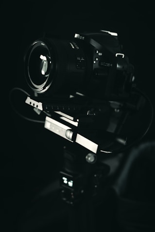 black dslr camera on black surface