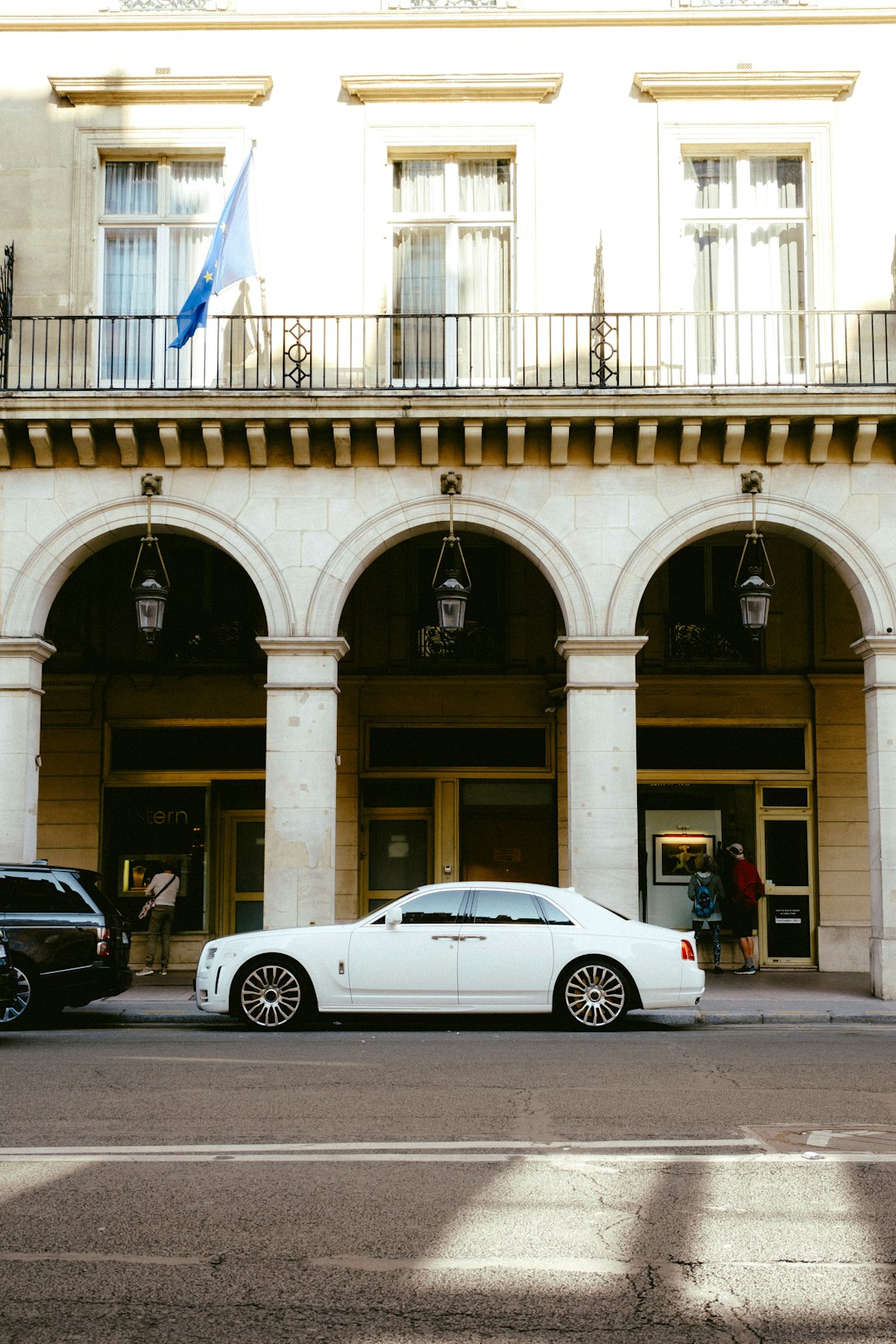 white porsche 911 parked beside black sedan