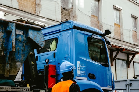 blue and white truck on road during daytime