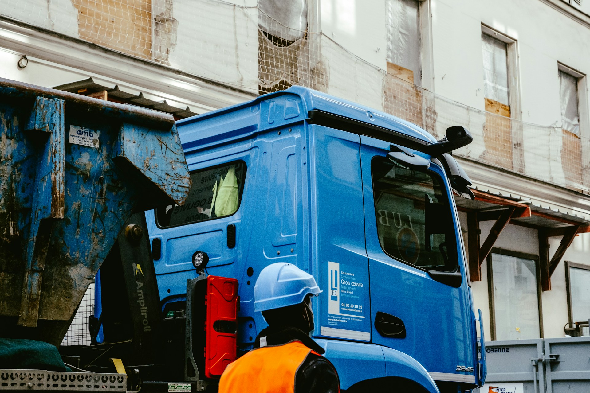 blue and white truck on road during daytime