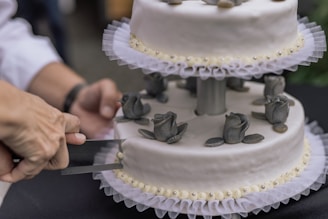 white and black cake with black icing on top