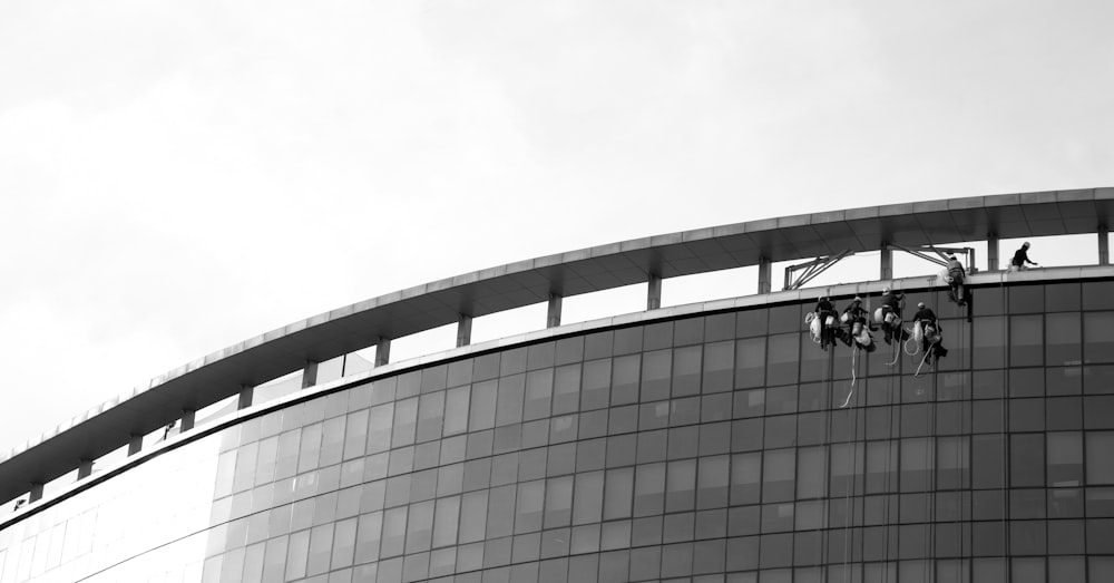 grayscale photo of building under cloudy sky