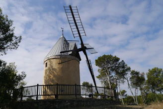 brown windmill under blue sky during daytime