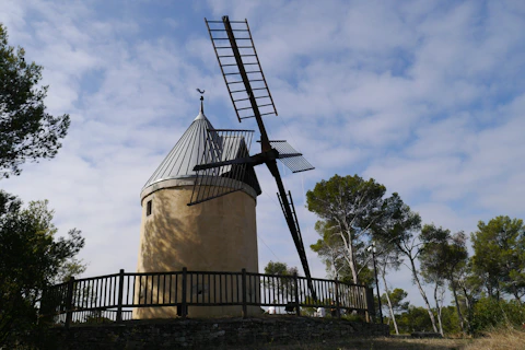 brown windmill under blue sky during daytime