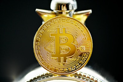 A close-up of a bitcoin coin on a financial report.