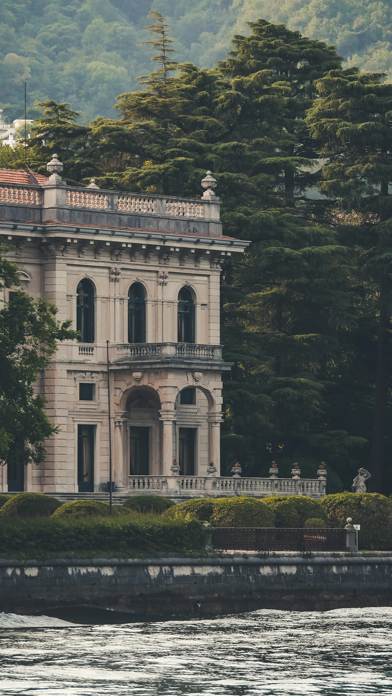 A villa half-hidden by mature trees