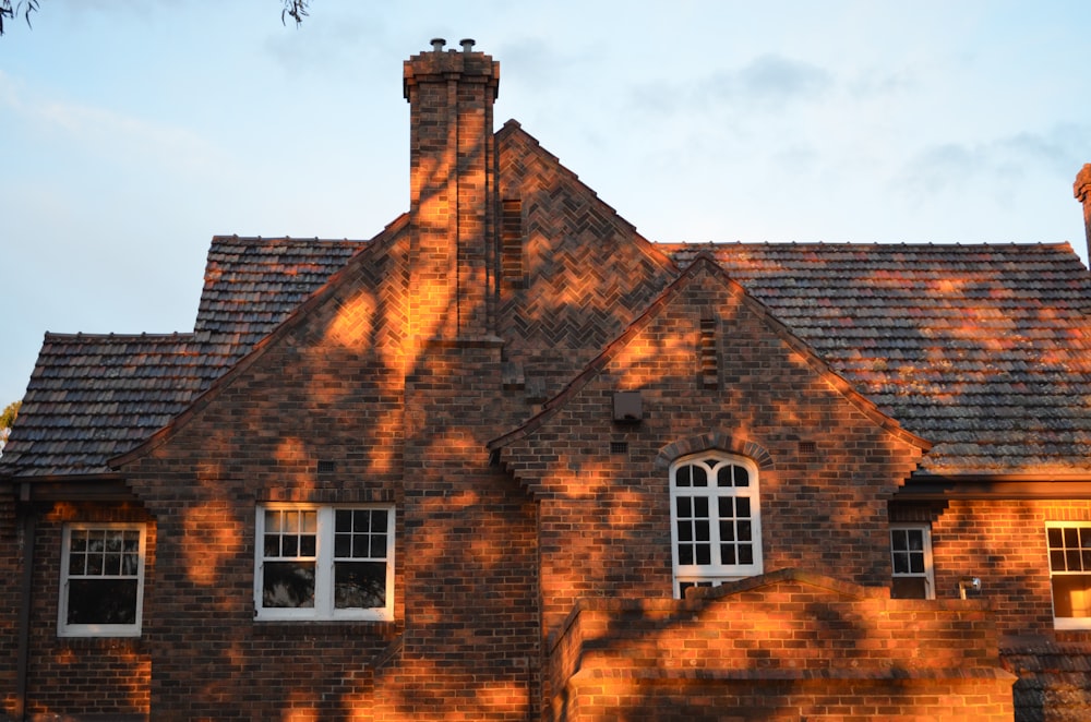 brown brick house under blue sky during daytime