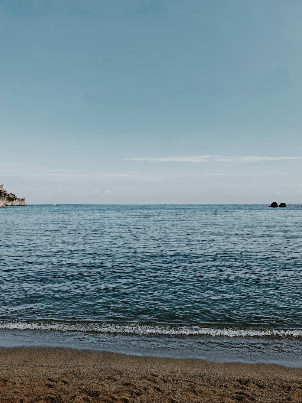 body of water under blue sky during daytime