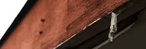 Detailed close-up of maintenance work on wooden structures.