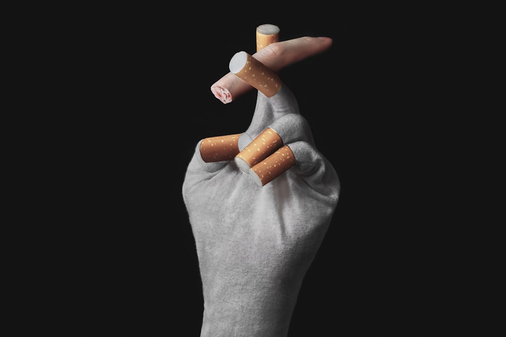 person holding orange medication pill