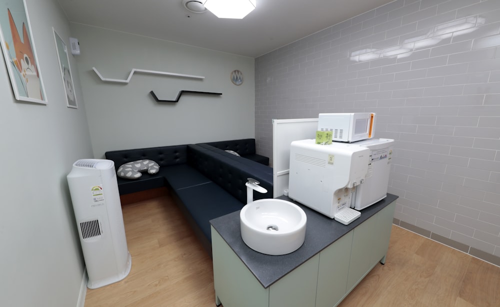 white ceramic sink beside black wooden bed frame