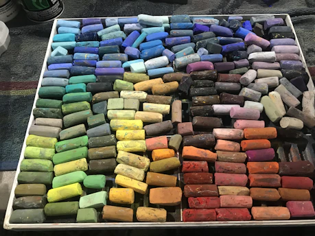 Soft pastel art prints arranged neatly on a wooden table