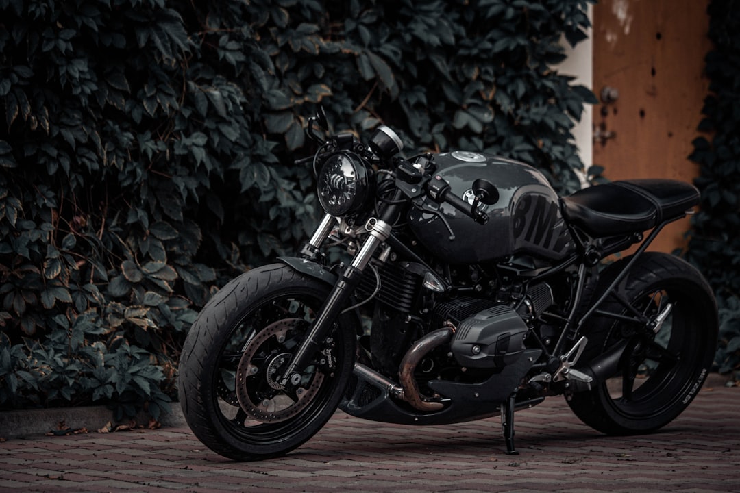 black and gray motorcycle parked on brown concrete floor