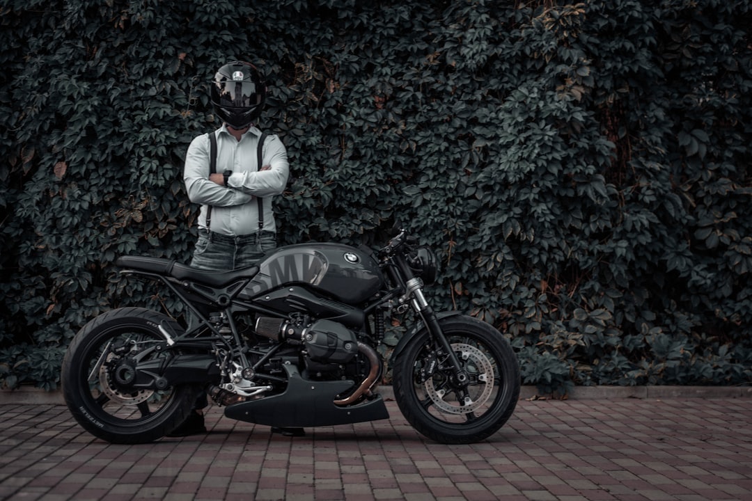 man in white jacket riding black motorcycle