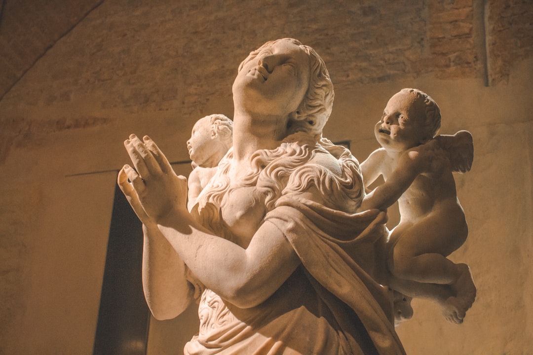 man and woman kissing statue