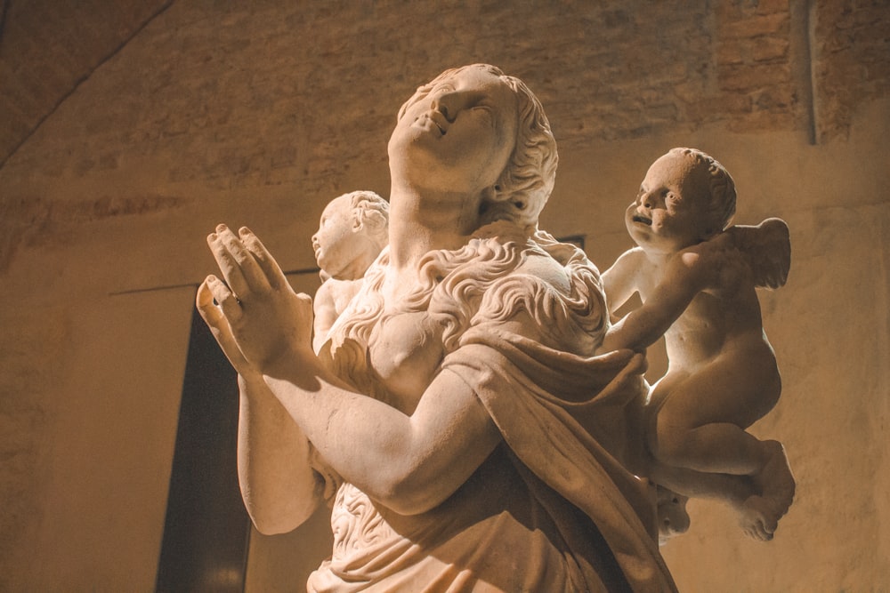 man and woman kissing statue