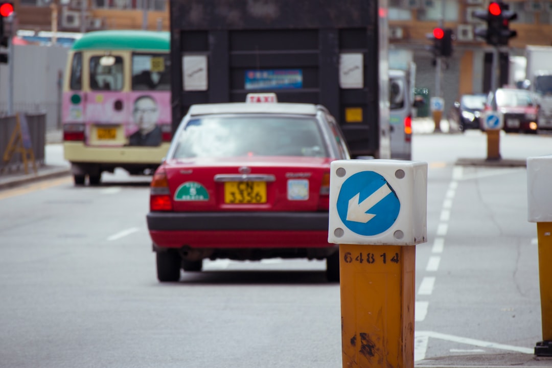 red and white taxi cab on road