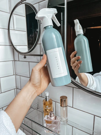 person holding white plastic bottle