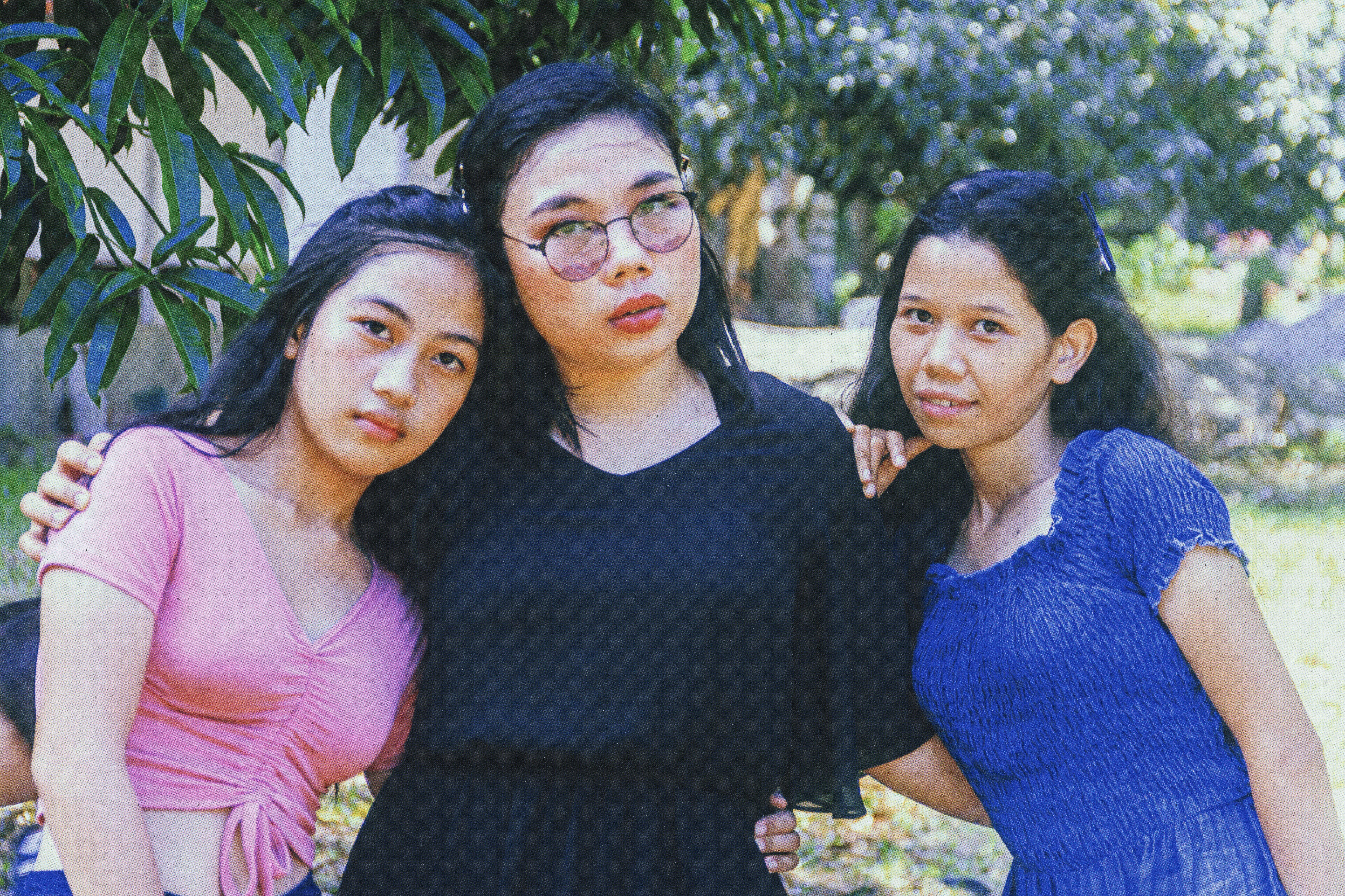 woman in pink tank top beside woman in blue dress