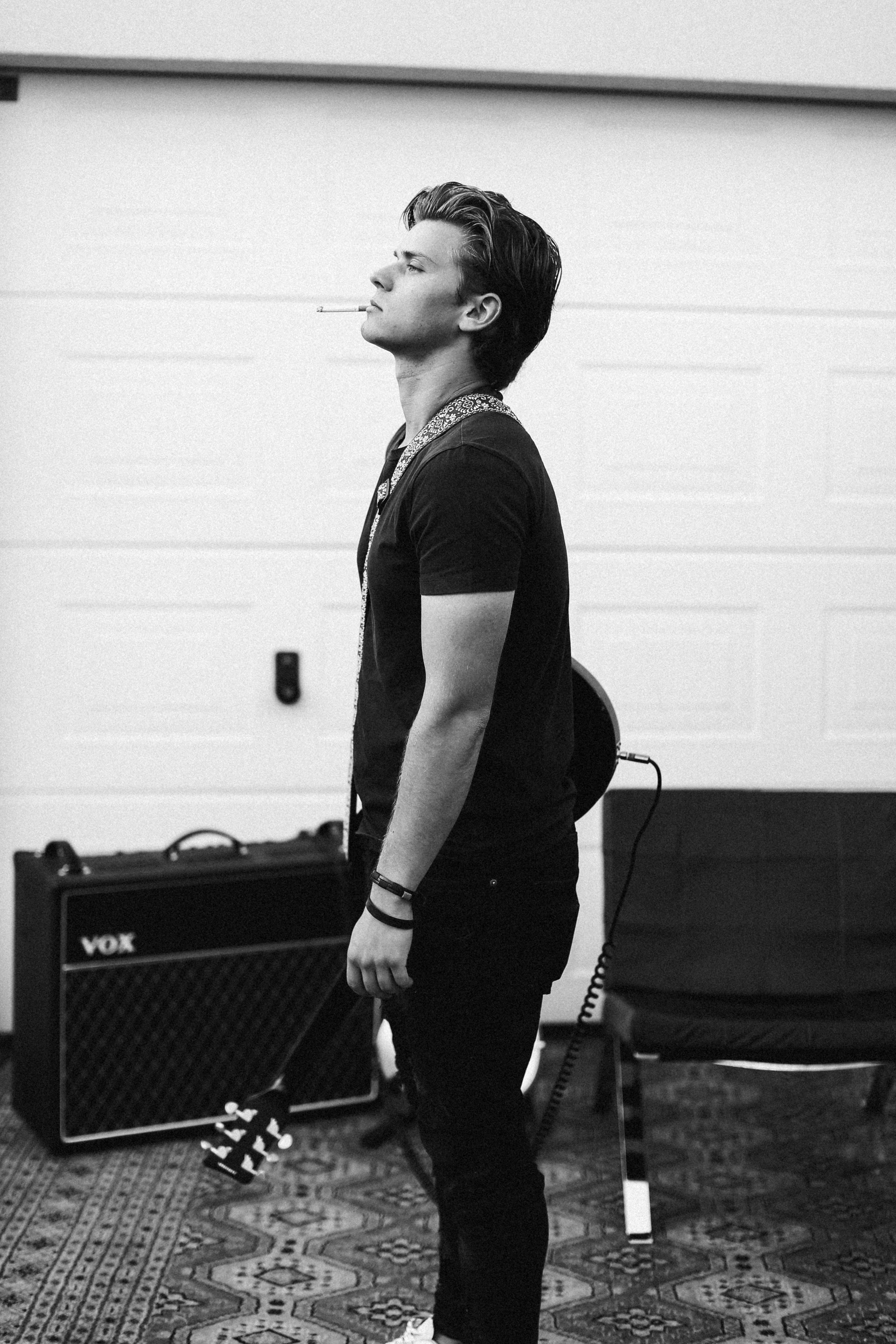 woman in black shirt and pants standing near black chair