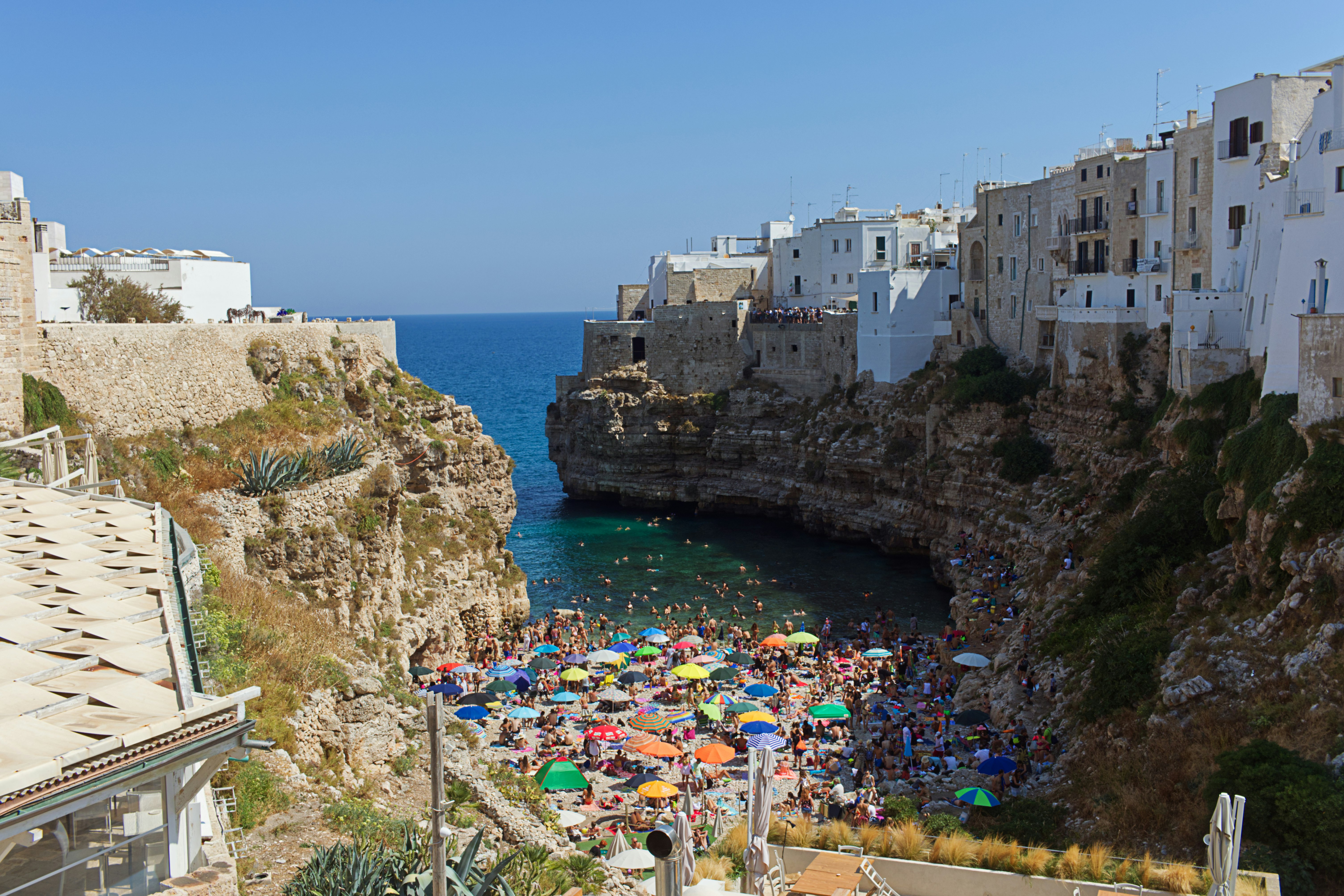 people on beach near buildings during daytime