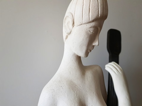 A serene sculpture of a woman's vulva in soft light.