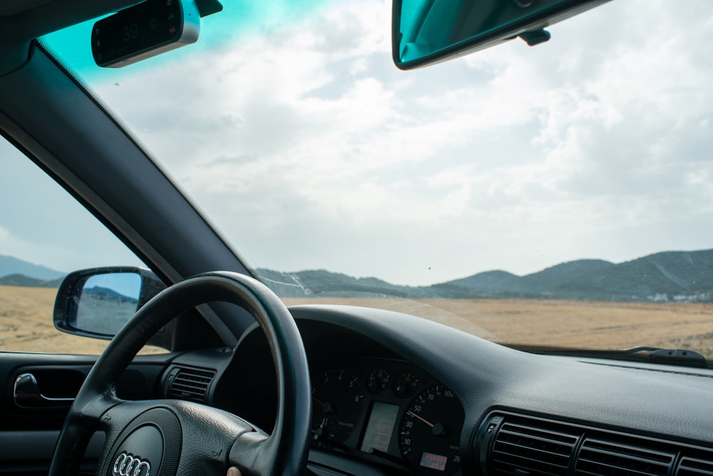 black car steering wheel during daytime