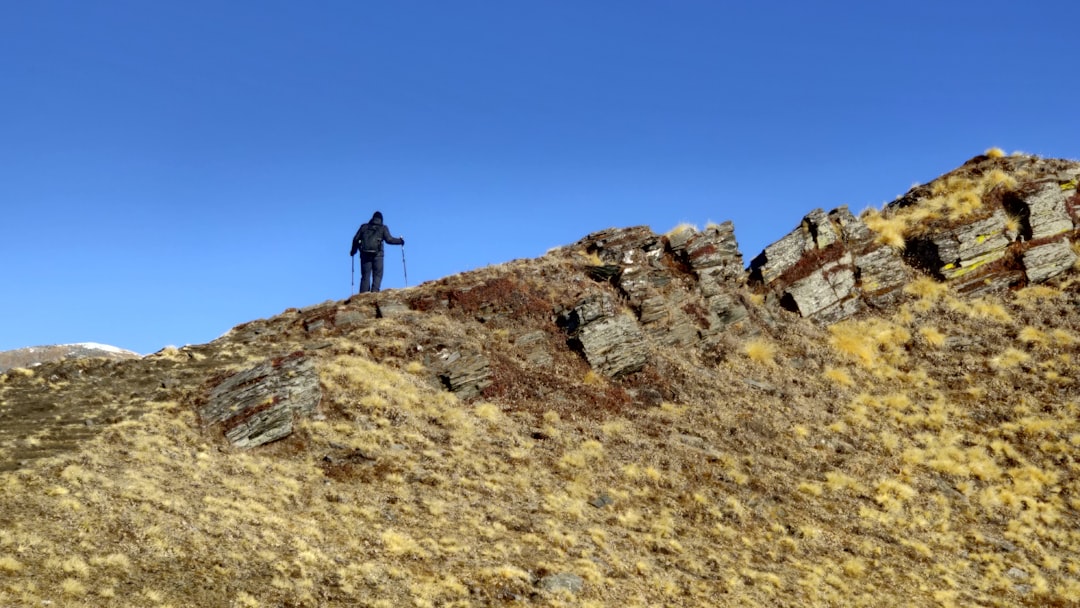 person standing on brown rock mountain during daytime
