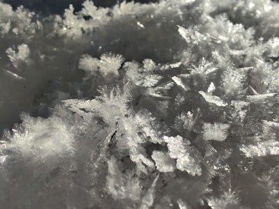 Macro shot of ice water hash crystals sparkling under lab lighting.