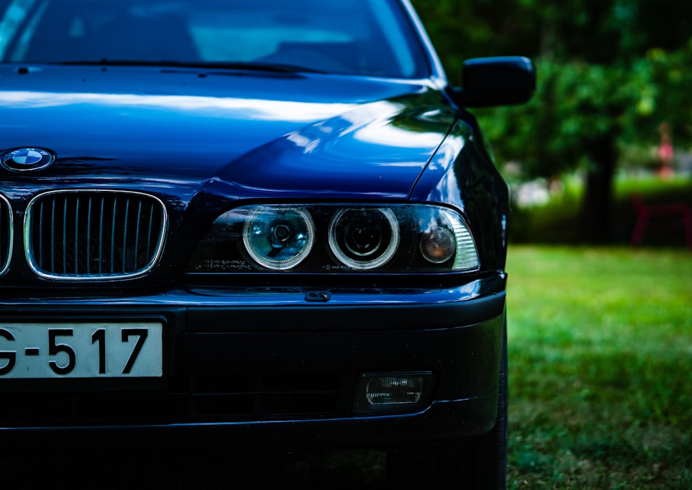 blue and white car on green grass field during daytime