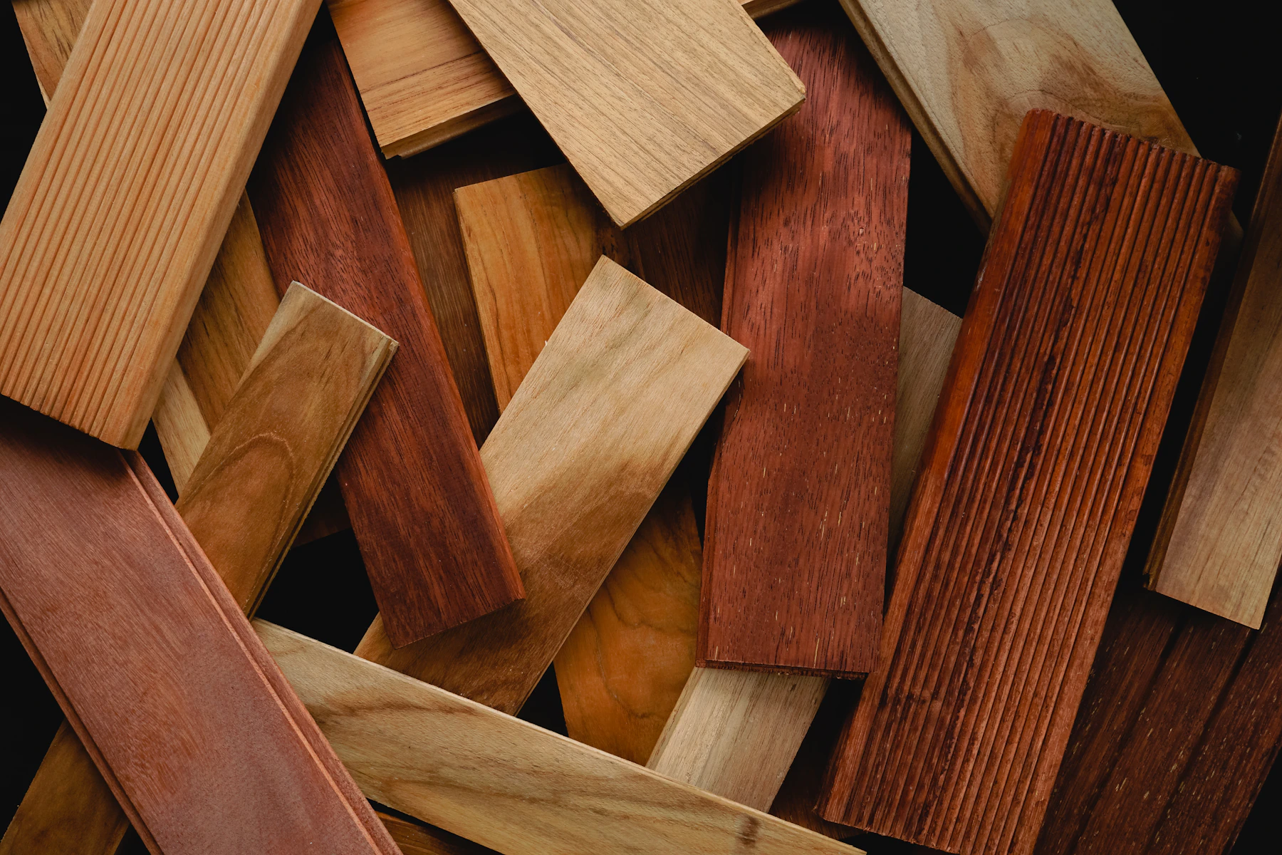 A close-up assortment of wooden floor samples with varied grain and colour